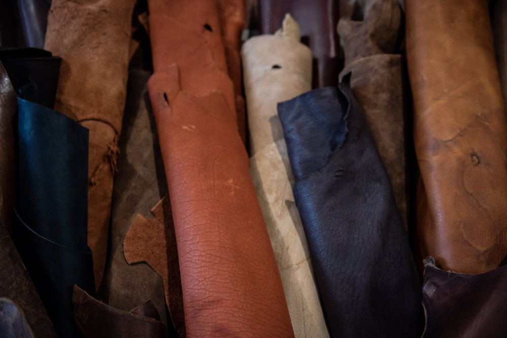 Rolled up swatches of leather in various colors and grains.