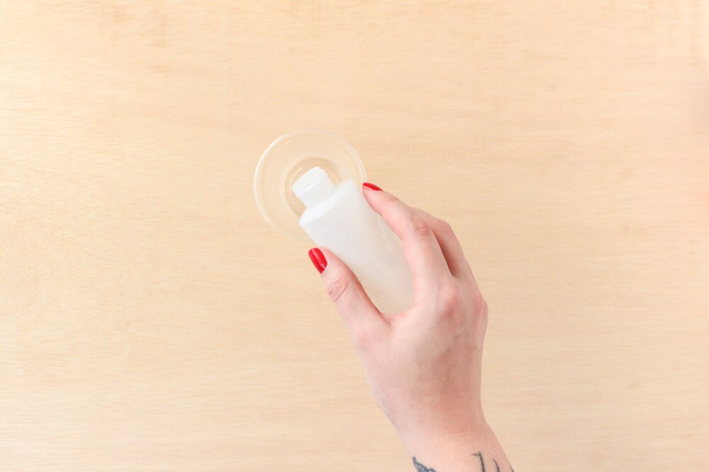 Rachel combines resin and hardner in a cup.