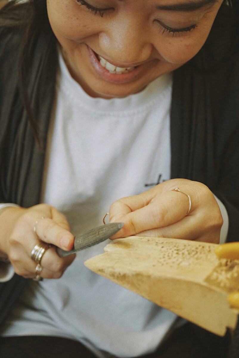 Katherine metalsmithing in her studio.