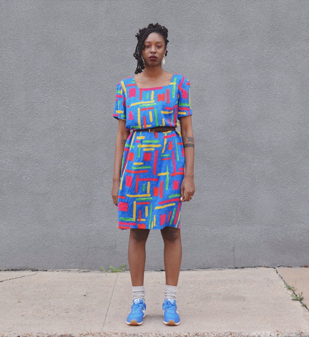 Rachelle models a colorful abstract print dress.