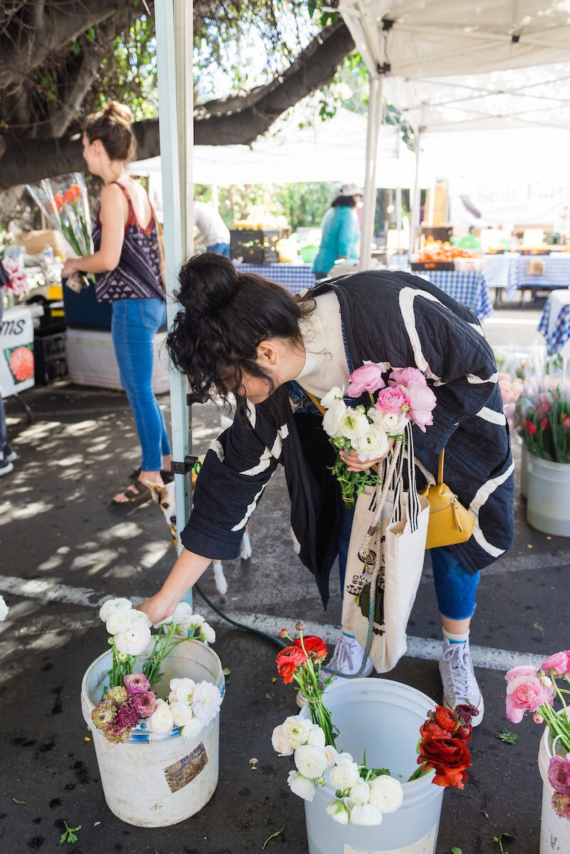 Melanie selects fresh flowers at the farmer's market