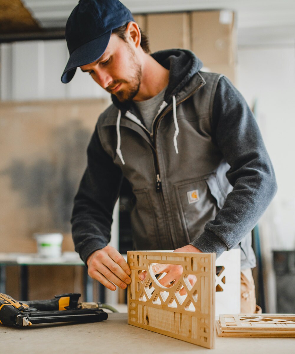 Andrew assembles a wooden milk crate.