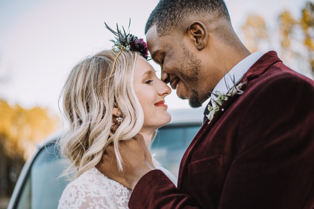 The bride and groom lean in for a kiss on their wedding day.