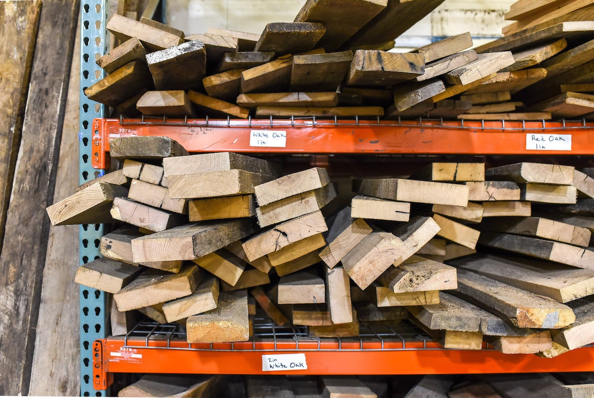 Wood grouped by type on shelves in the What WE Make workshop