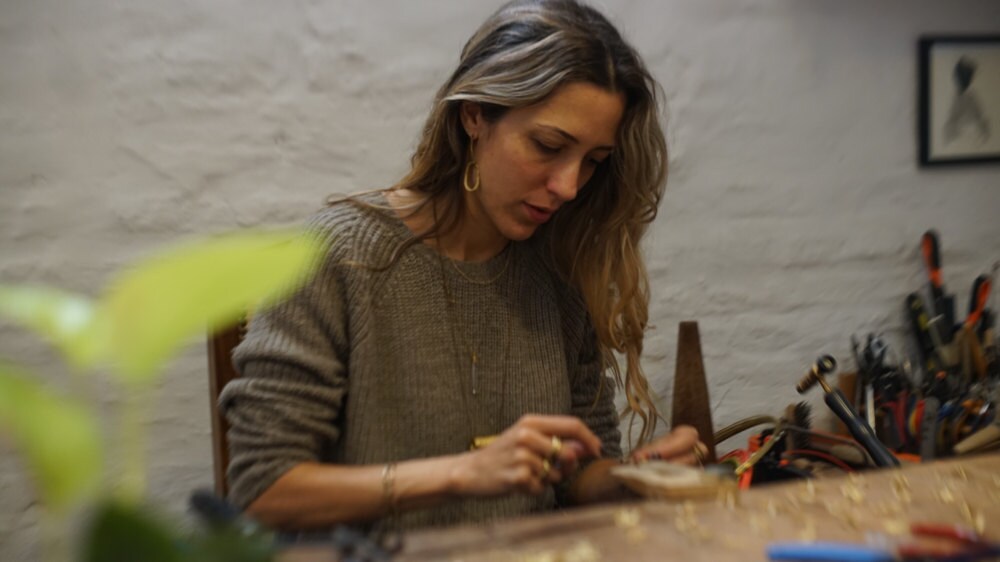 Maria Solorzano making jewelry in her studio