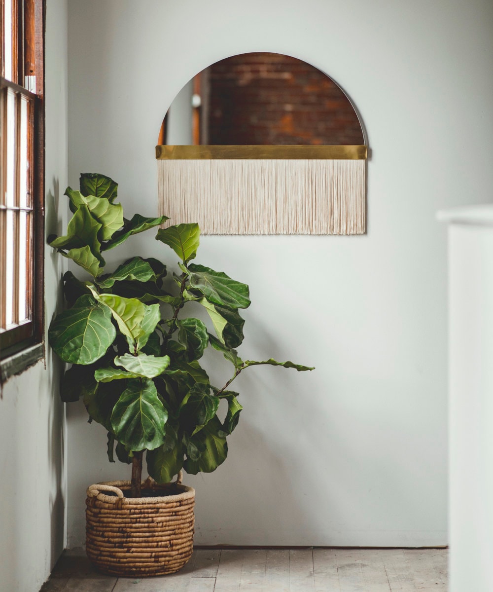 A medium "Aria solo" half-circle fringe mirror from Candice Luter.