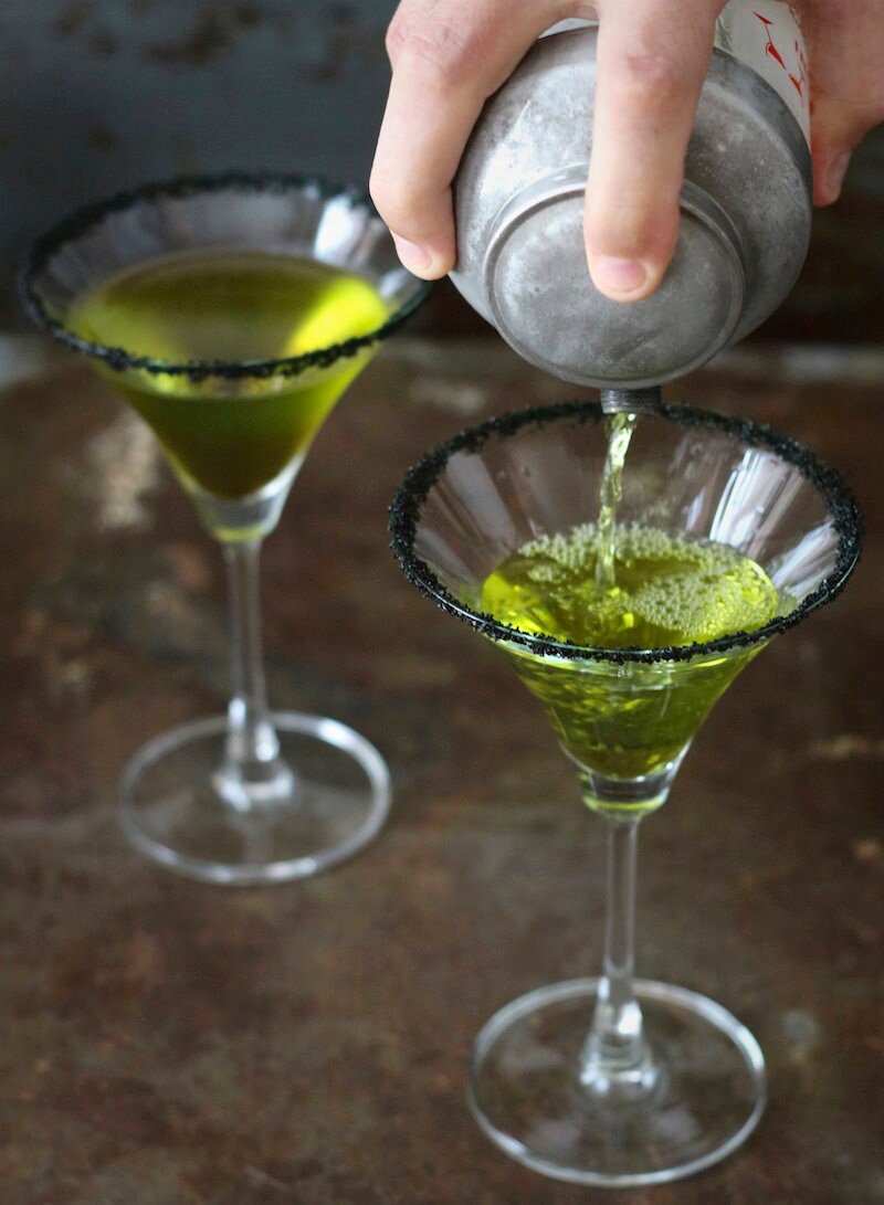 Green poison apple cocktails served in martini glasses