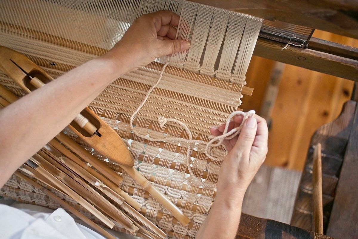 A closeup of the weaving process