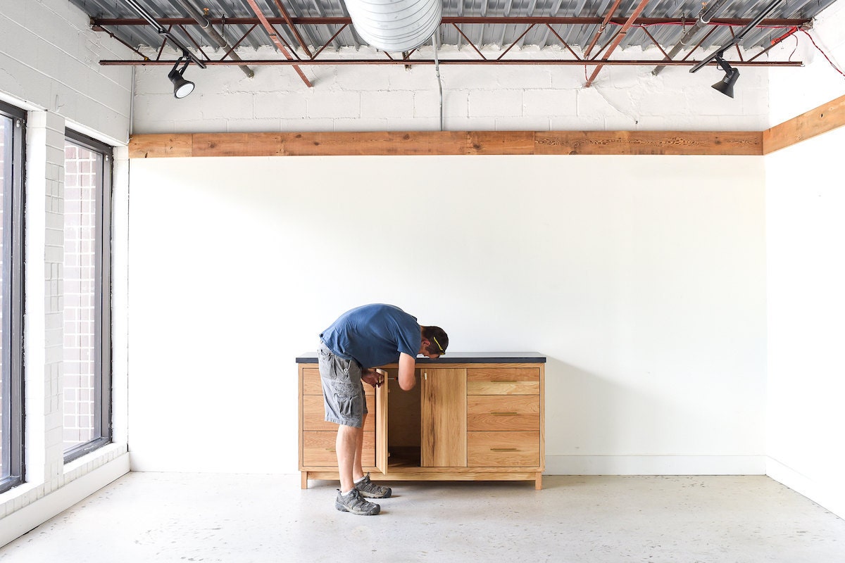 George adjusts the hardware on a vanity