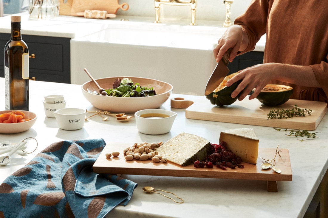 A kitchen island styled with elevated cooking staples