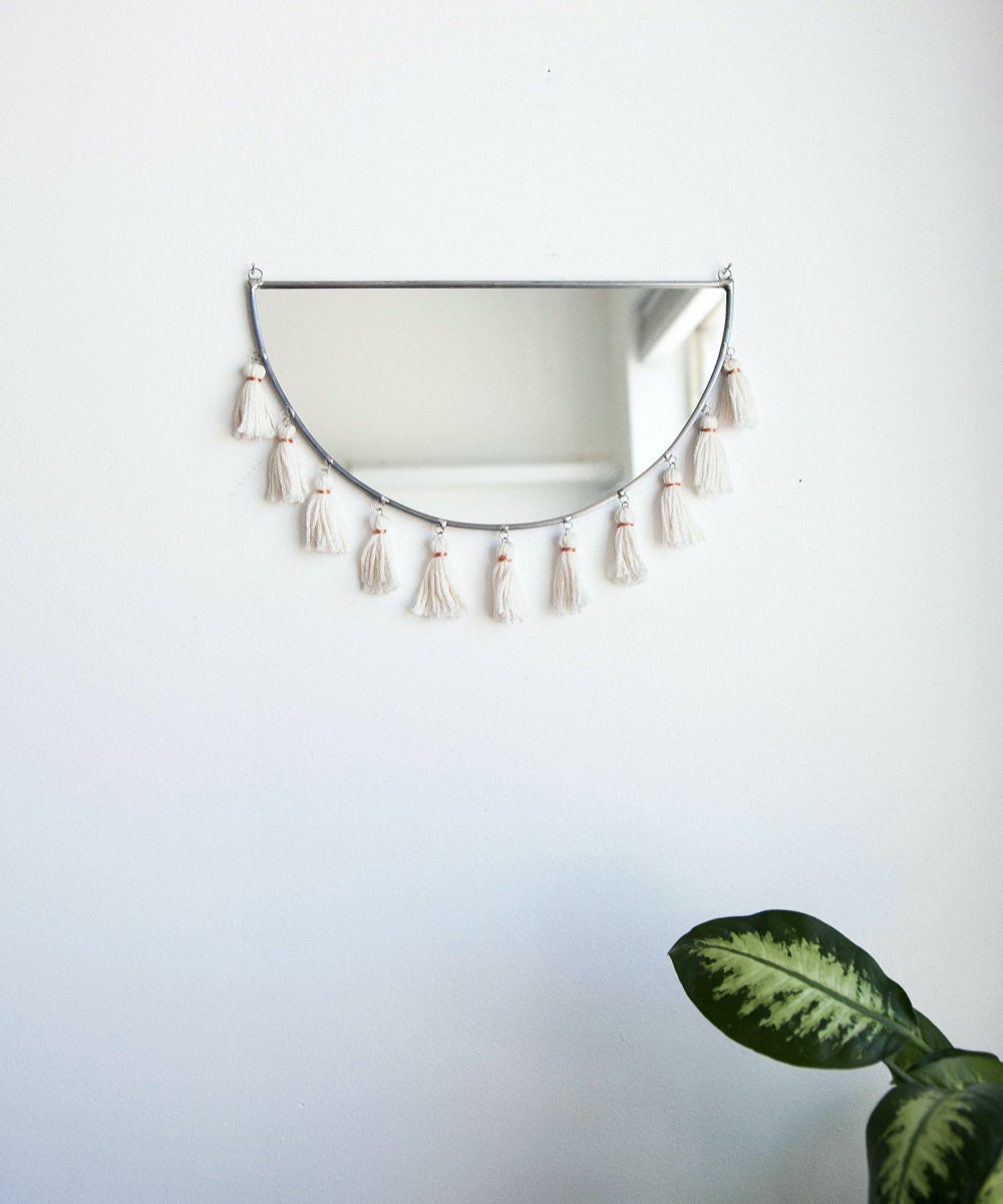 A half-moon tassel mirror from Szklo Glass