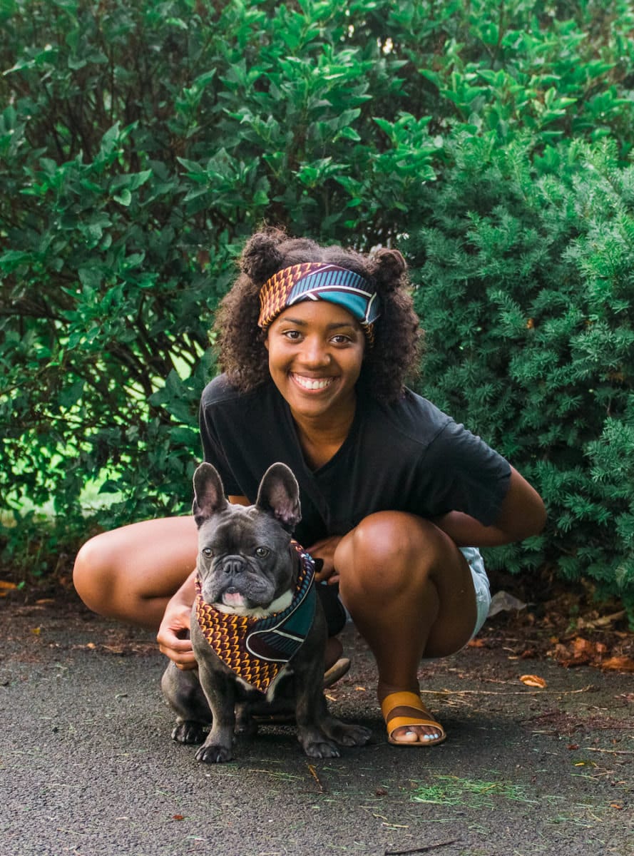 A woman and her French bulldog model a matching head wrap and bandana.