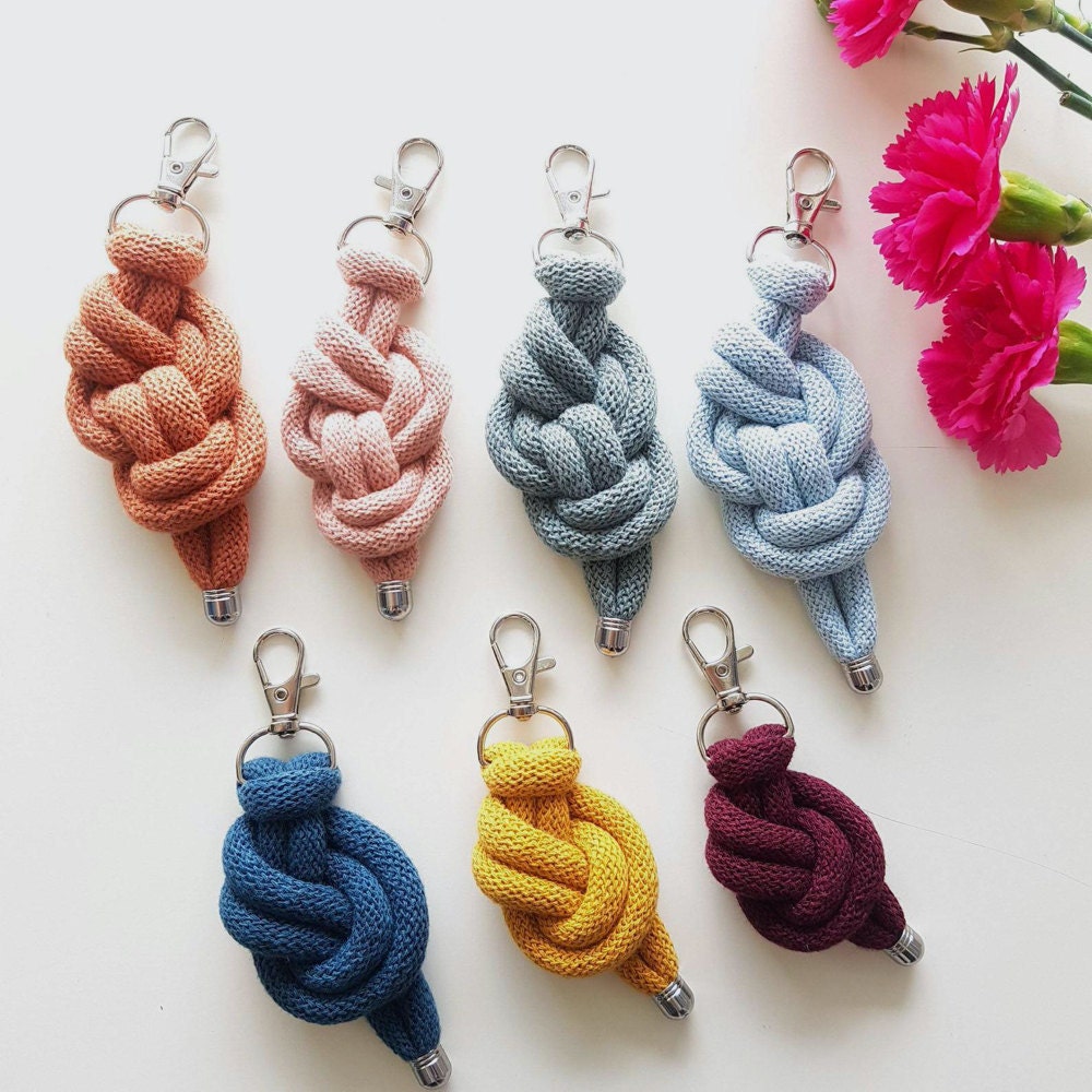 An assortment of knotted cord keychains in various colors.