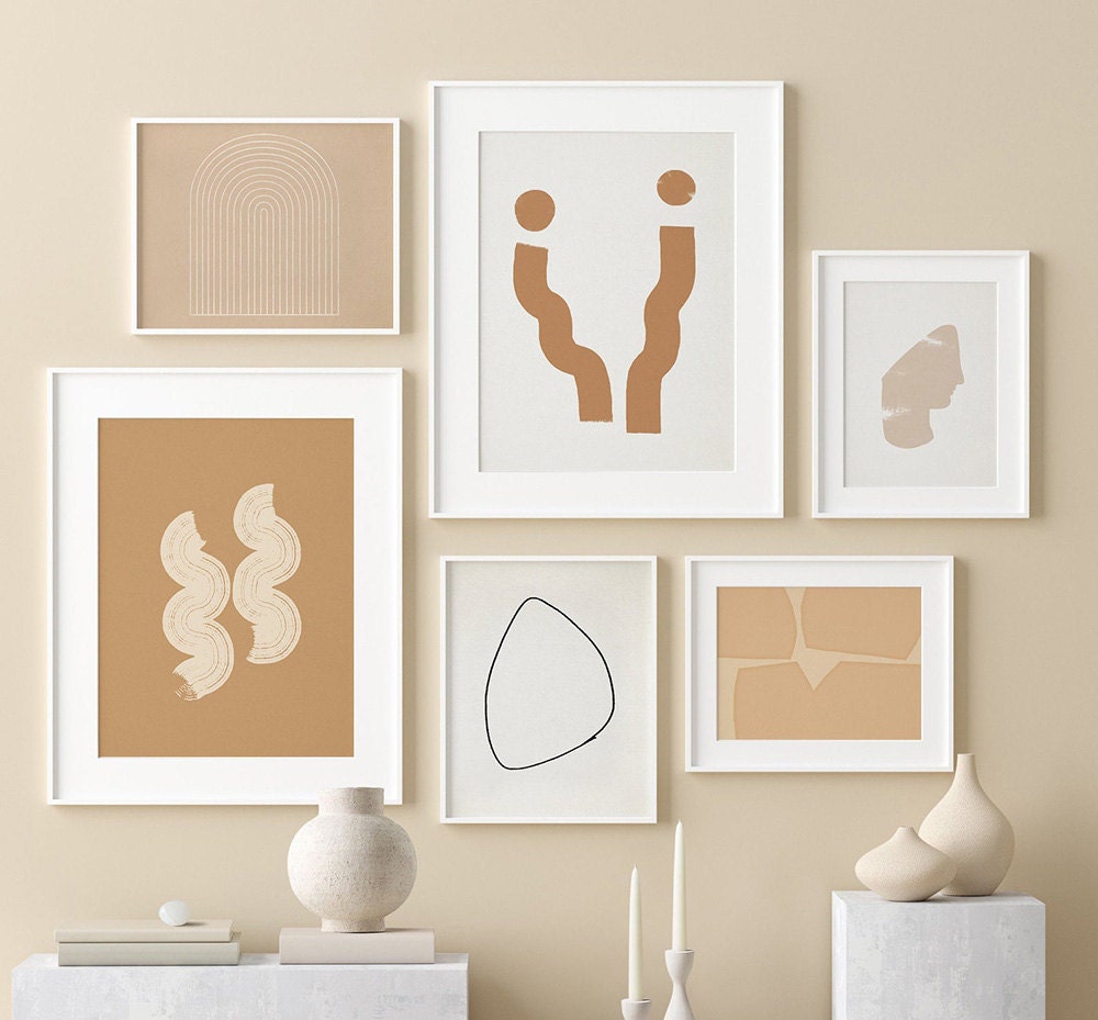 A gallery wall with abstract designs in warm colors.