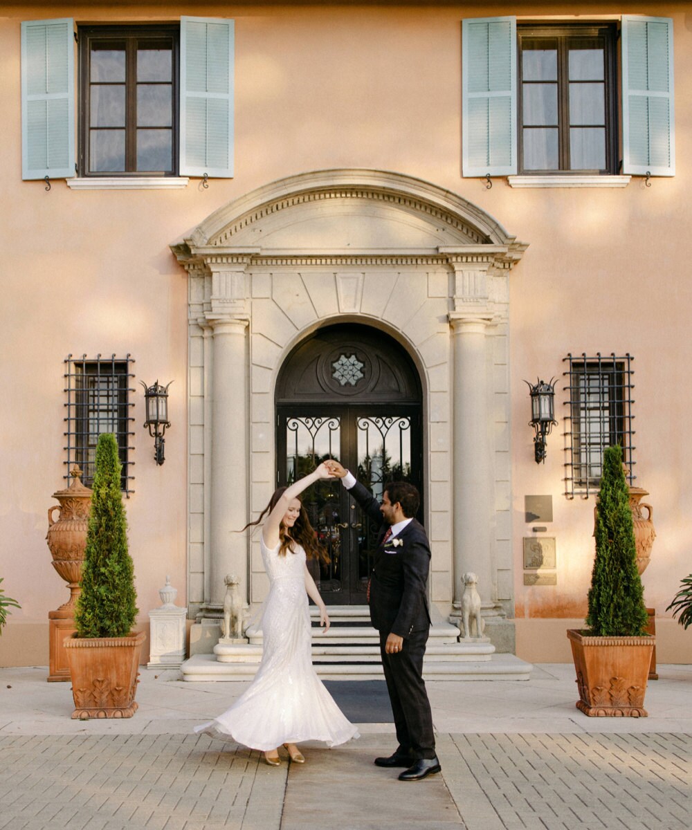 A portrait of Imran twirling Megan on their wedding day.