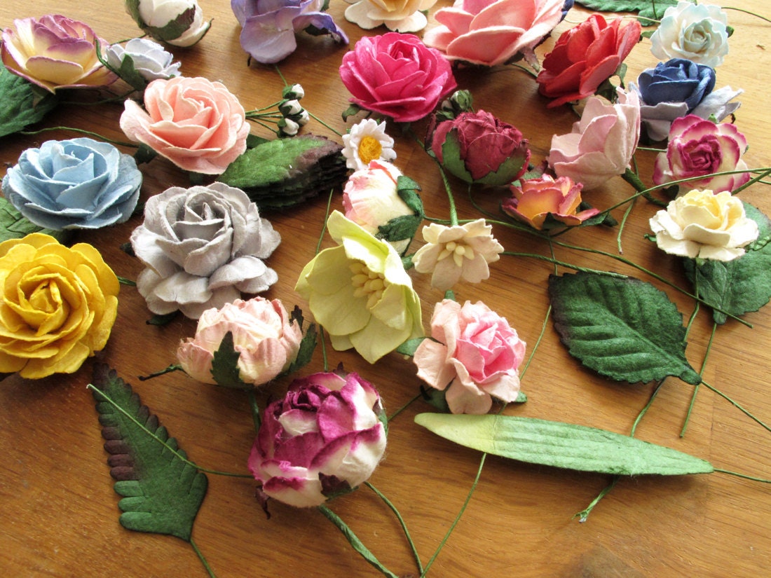 Multi-colored paper florals laid out on Orawee's tabletop