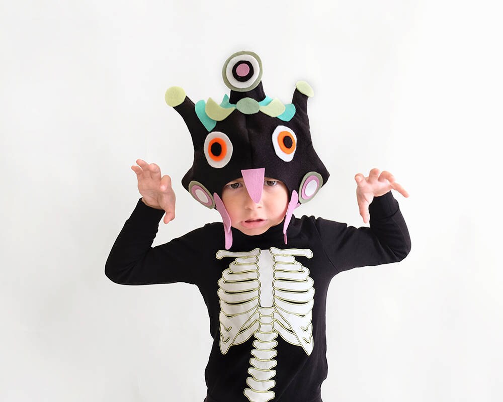 A child makes his best scary face while wearing a hand-sewn monster mask created from a pattern by ImaginaryTail.