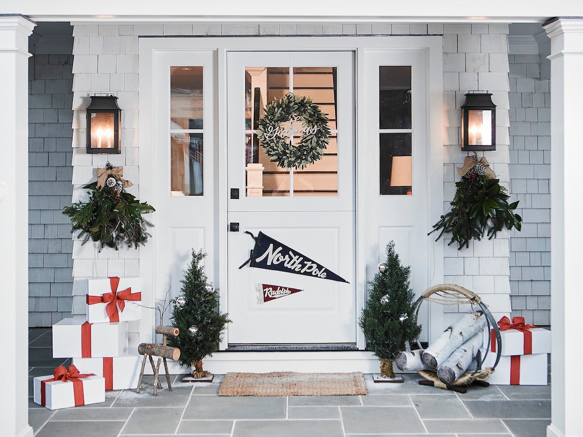 A front door styled with rustic decor for the holidays.