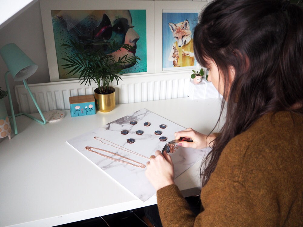 Mica Peet assembling necklaces.