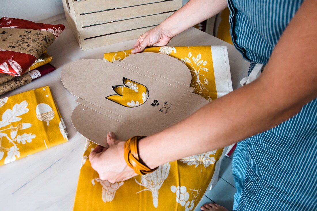 Tatiana begins prepping a package for shipment