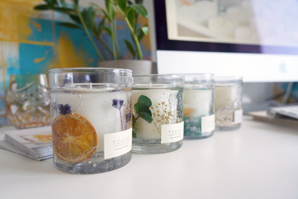 A row of candles from Rino's botanical collection lined up on her desk