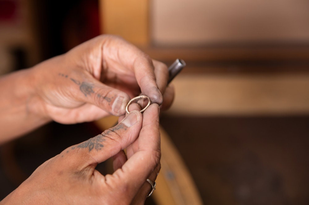 Tamara Gomez holding a finished gold ring