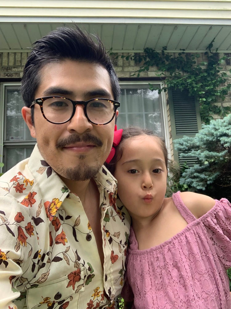 A portrait of Etsy Senior Account Security Agent Ramon Gutierrez and his daughter.