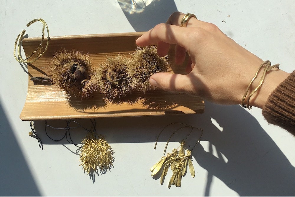 Maria arranges some of her inspirational finds from nature alongside a few of her finished pieces.