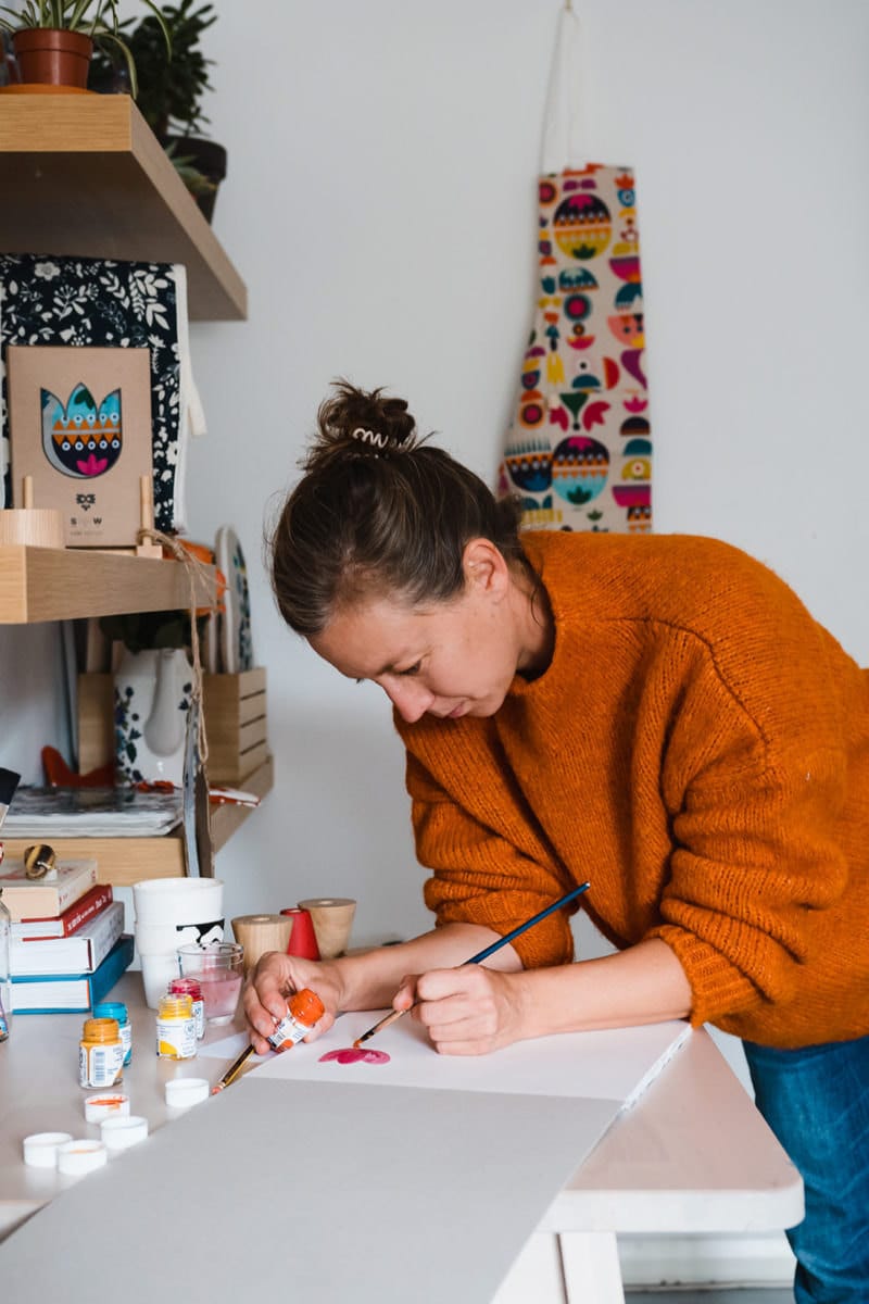 Tatiana painting at her work bench