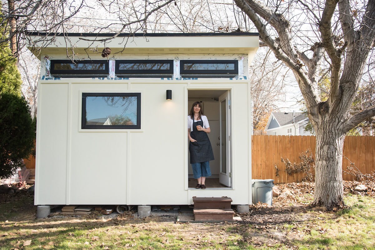 Sarah standing in the doorway of her backyard studio shed Sarah standing in the doorway of her backyard studio shed