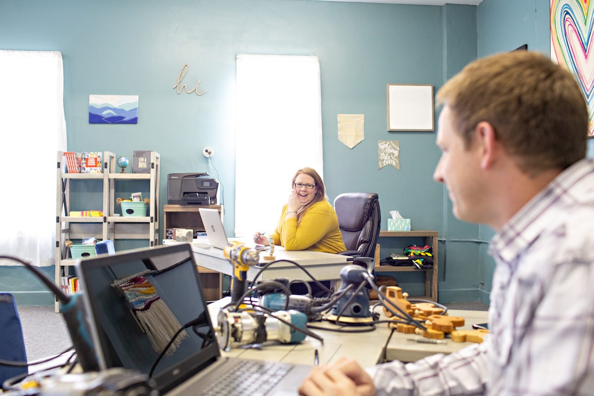 Stacey and Jesse Bannor chatting at their desks in the Bannor Toys office