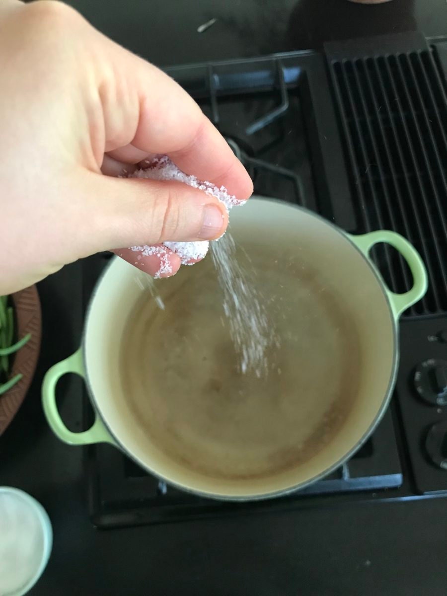 Adding salt to the boiling water Adding salt to the boiling water