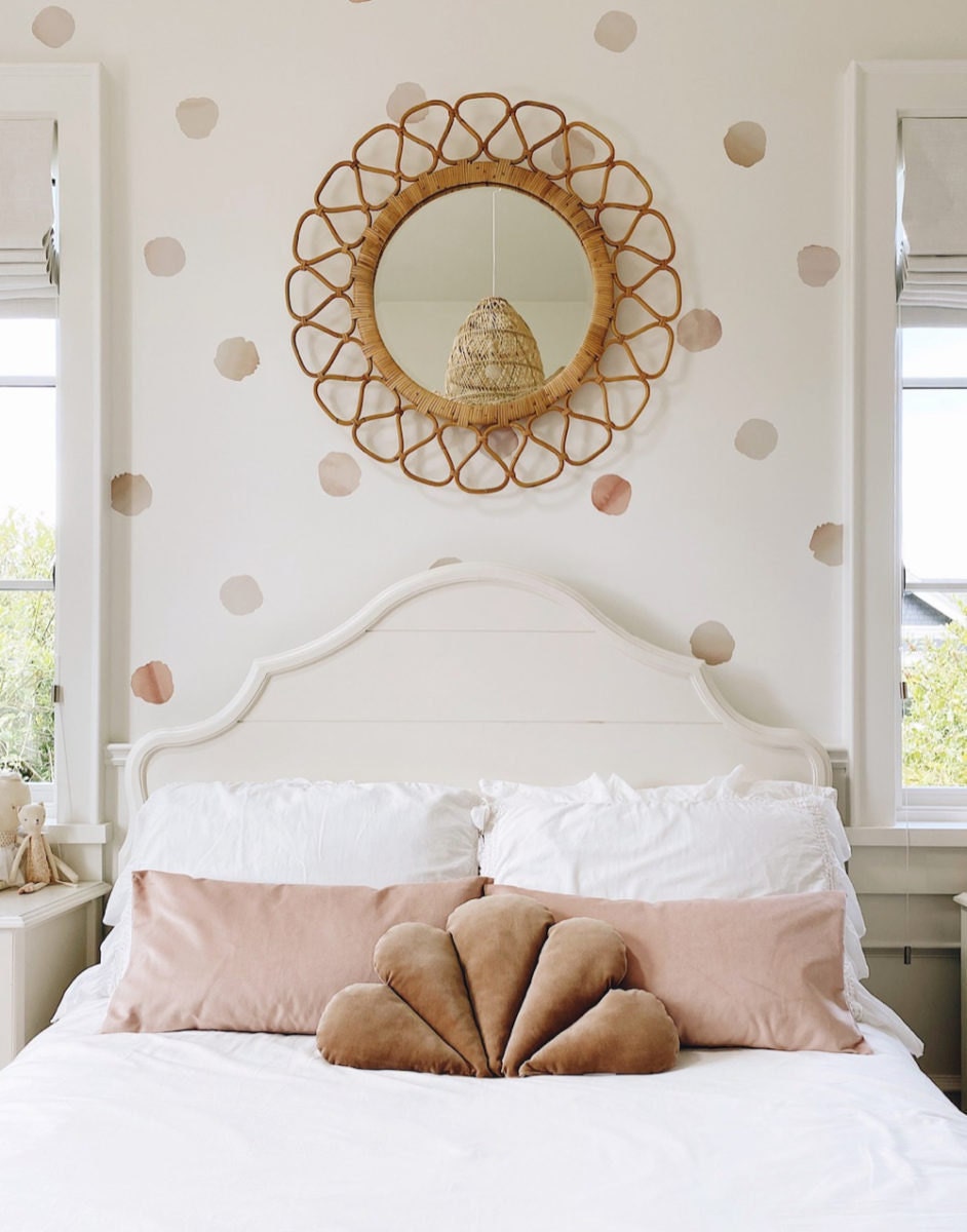 A bed styled with velvet throw pillows.