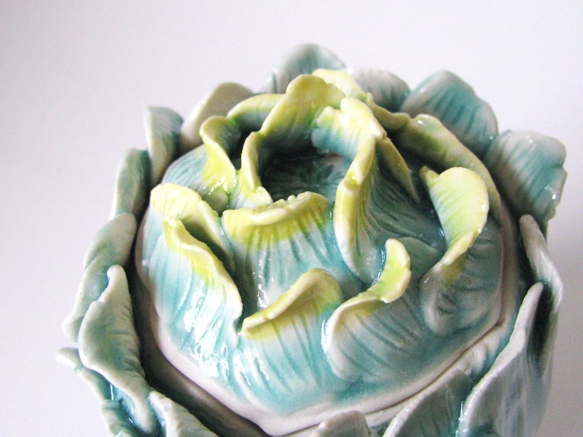 Detail shot of blue and green porcelain lidded vessel from Echo of Nature
