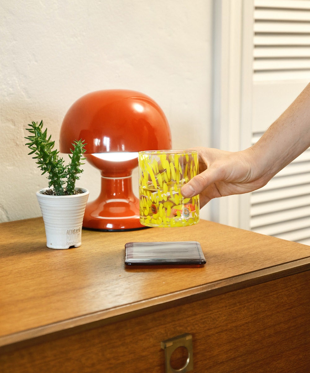 A vintage red mid-century lamp from Seconda Giovinezza on Etsy, styled on a desk.