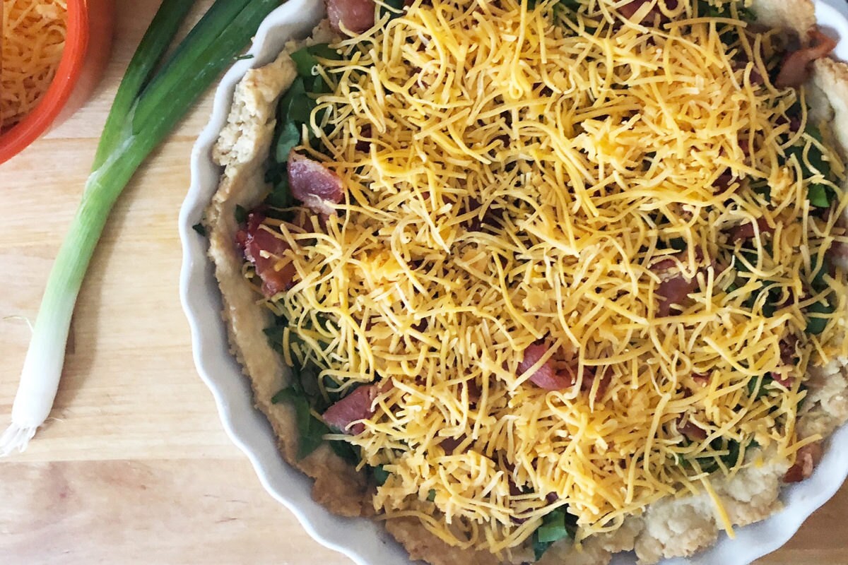 Layering in cheese and bacon Layering in cheese and bacon