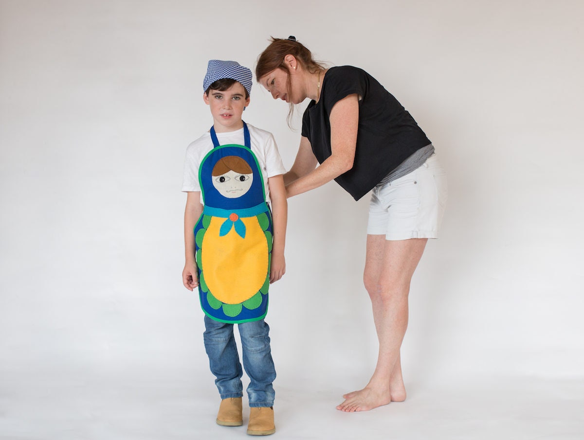 Inbal adjusting a costume on her son