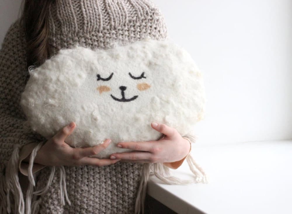 A cloud-shaped pillow made from felted wool from Agnes Felt