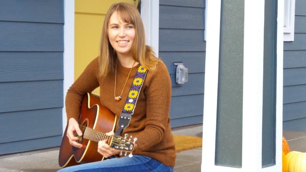 Sarah tests out one of her guitar straps