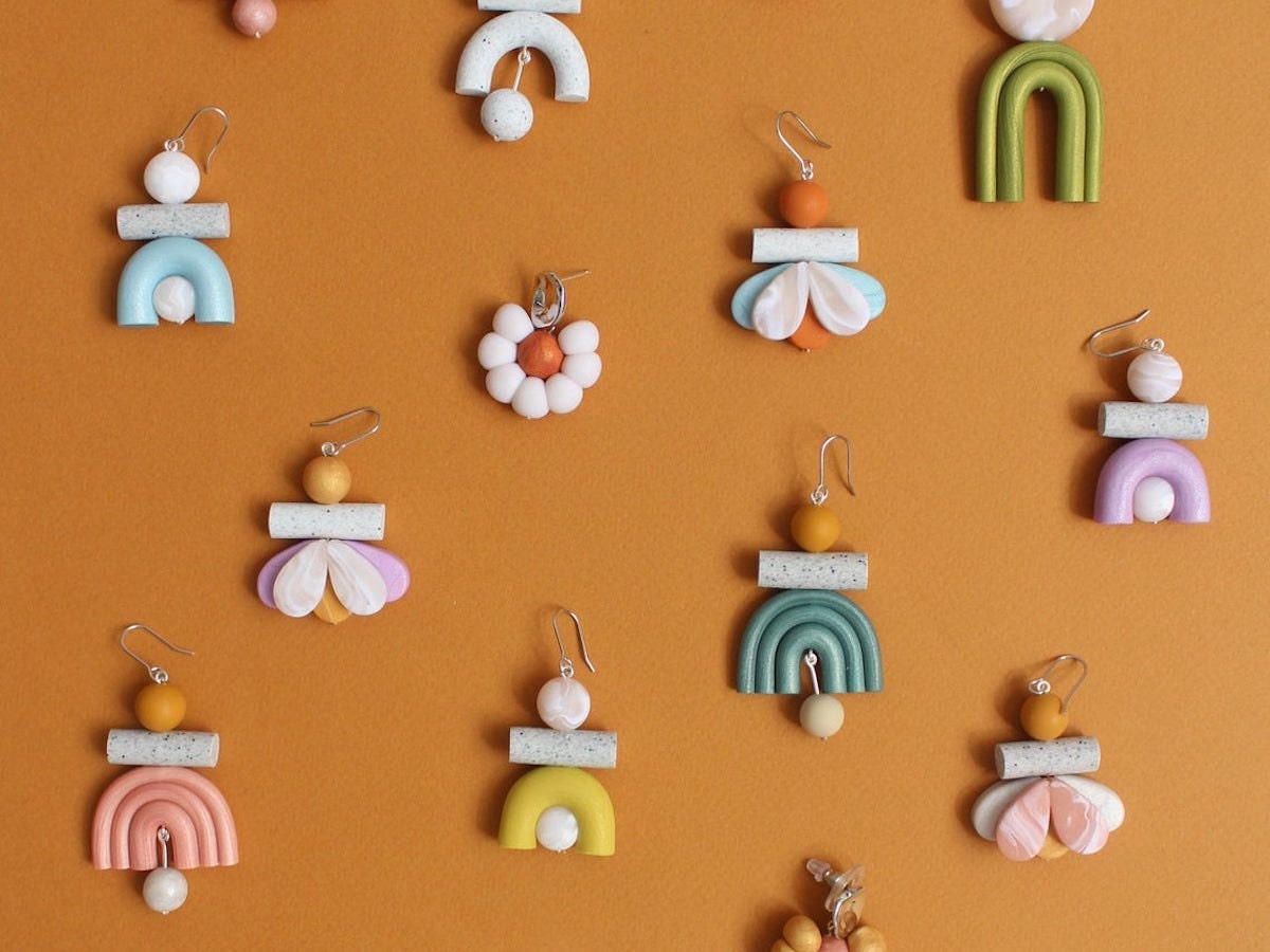 A flat lay of colorful polymer clay statement earrings from TSUNJA