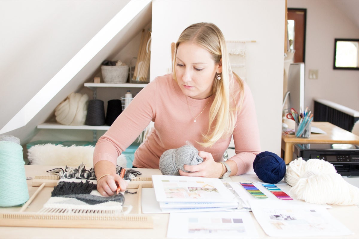 Ashley works on the design for a new loom kit at her desk.