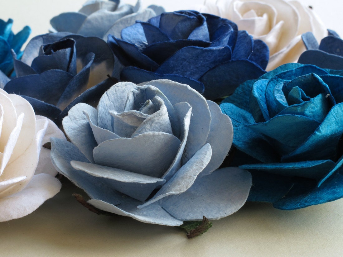 Details and texture on a selection of paper flowers in various shades of blue