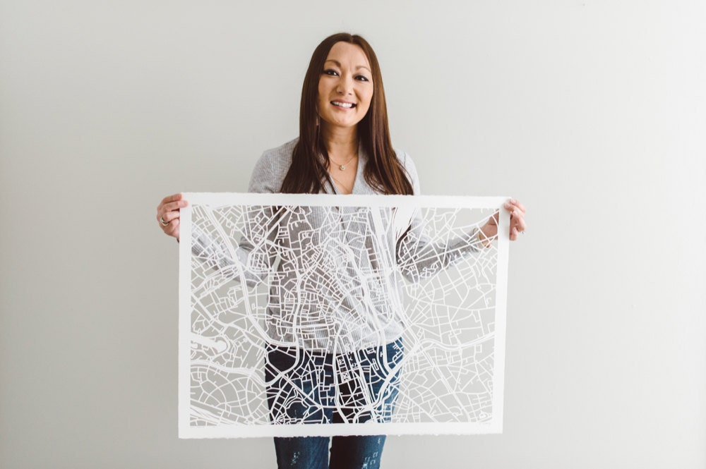 Karen holding a large paper-cut map