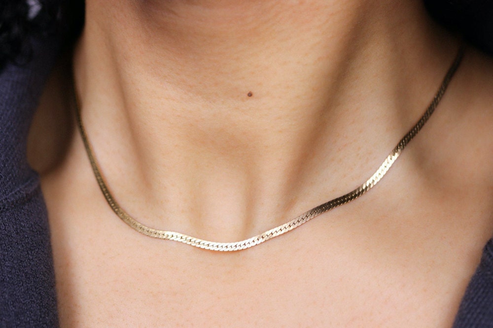 A gold herringbone necklace chain from EVREN.