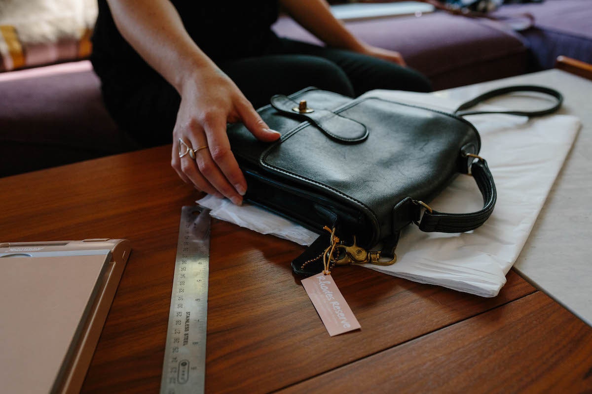 Brenda packing up a Coach bag to be shipped to a customer