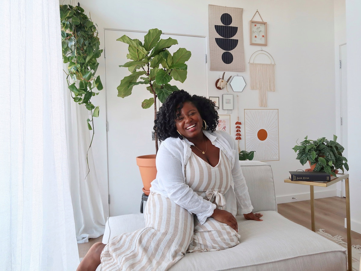 Janea Brown in front of her new gallery wall