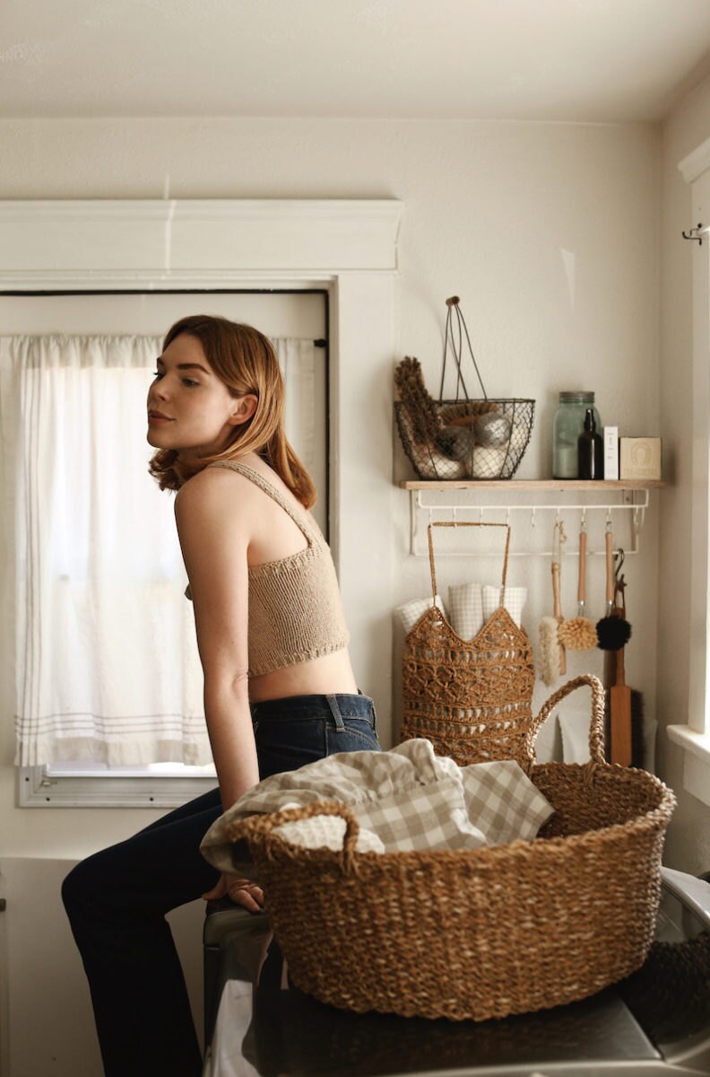 Courtney in her kitchen wearing a knit crop top from Plexida