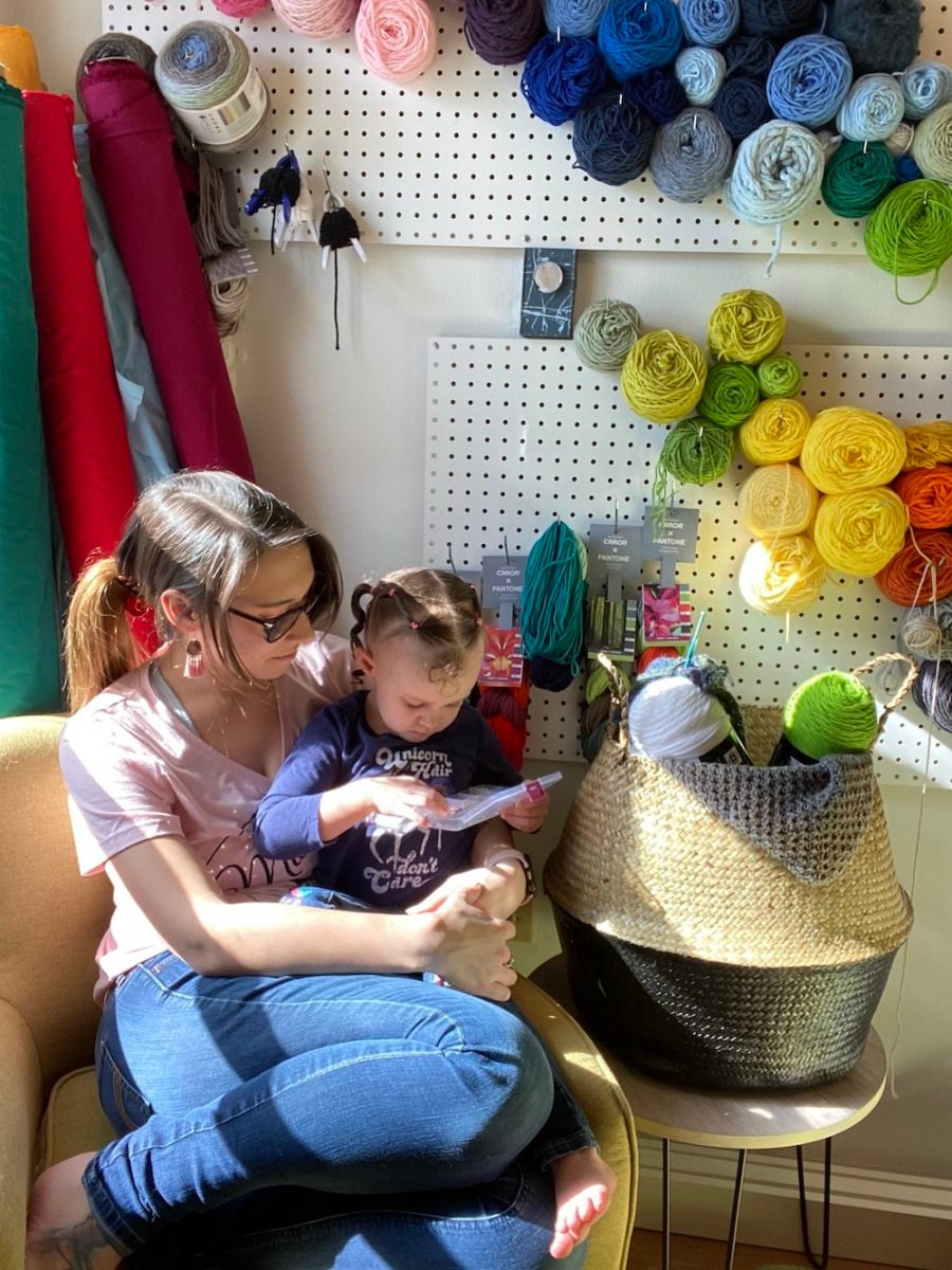 A portrait of Etsy Vetting Team Lead Amber-Rae Rowley and her daughter