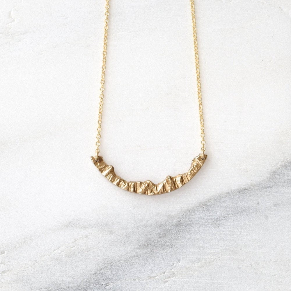 Gold mountain necklace from Everli