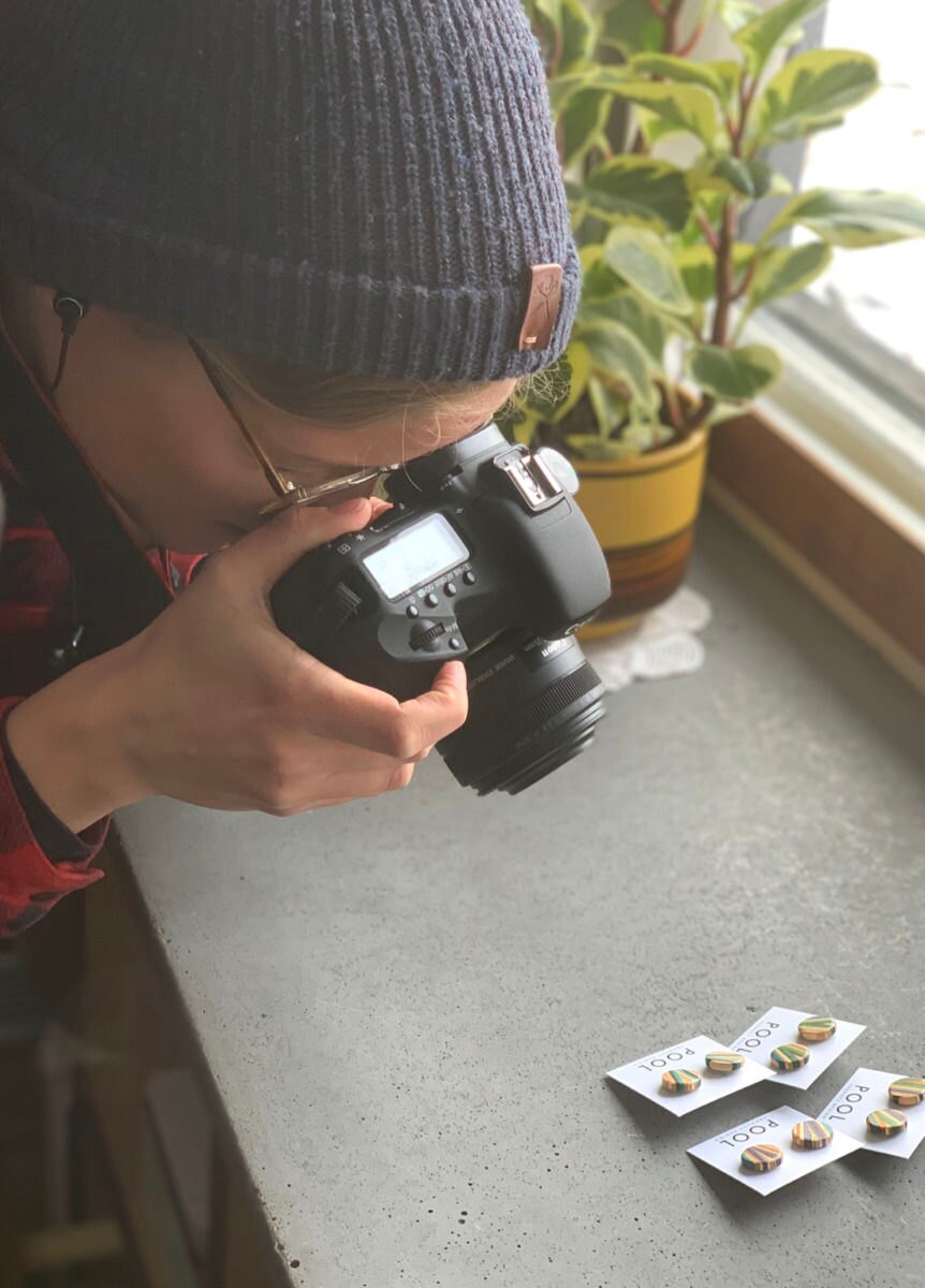 Anne photographs batches of recycled skateboard earrings